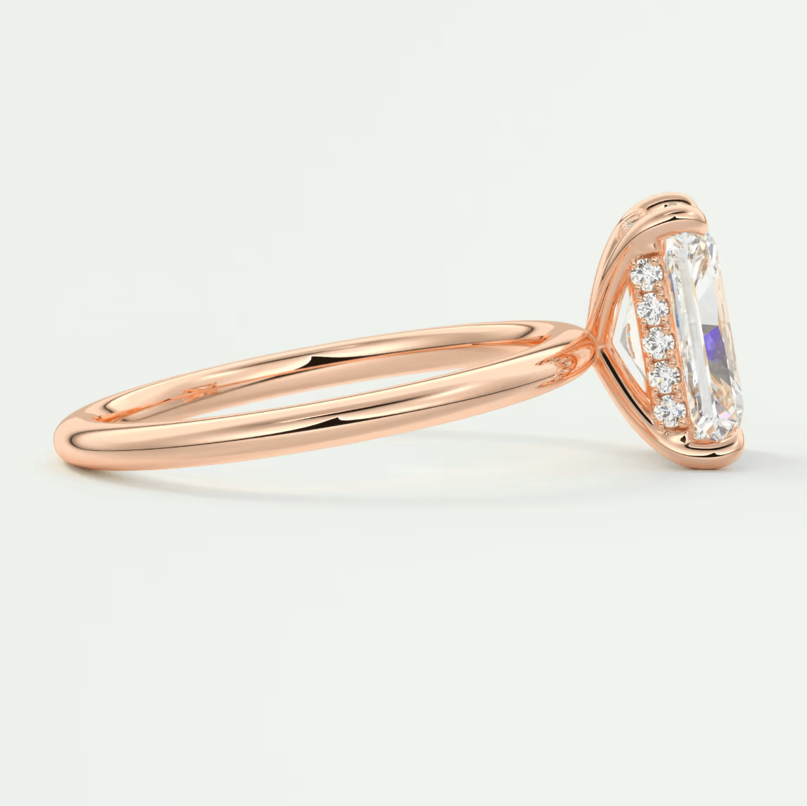 18k rose gold engagement ring with emerald-cut diamond and halo design.