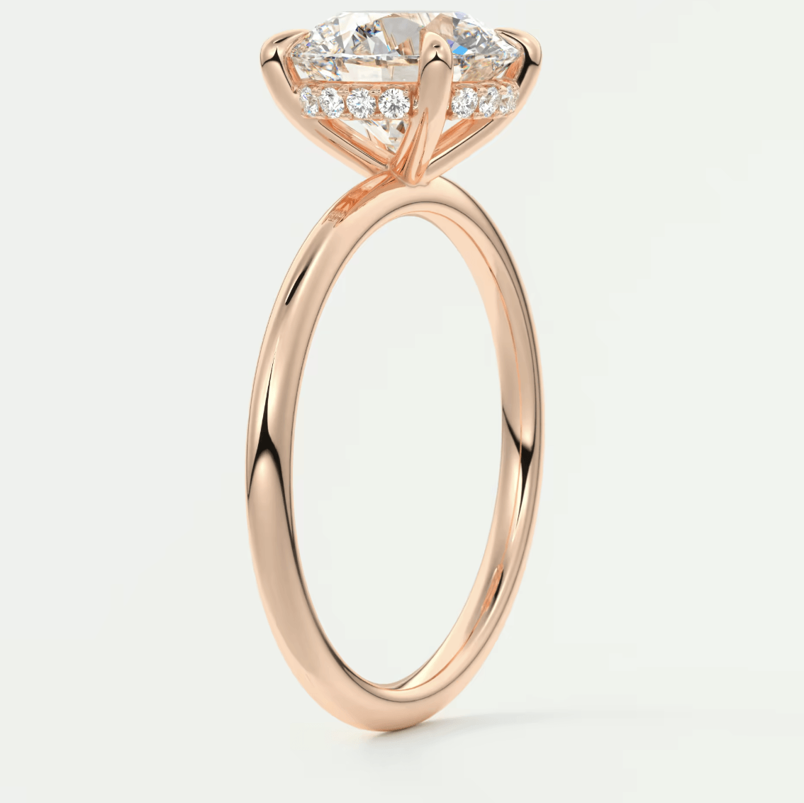 18-karat rose gold engagement ring with a marquise-cut diamond center stone and pave-set diamonds on the band.