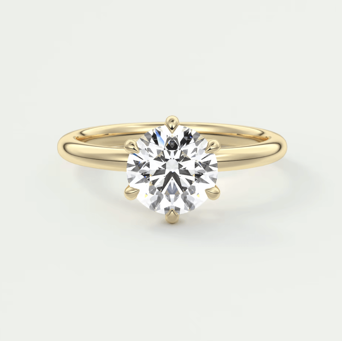 18k yellow gold solitaire diamond engagement ring with a round brilliant cut stone.