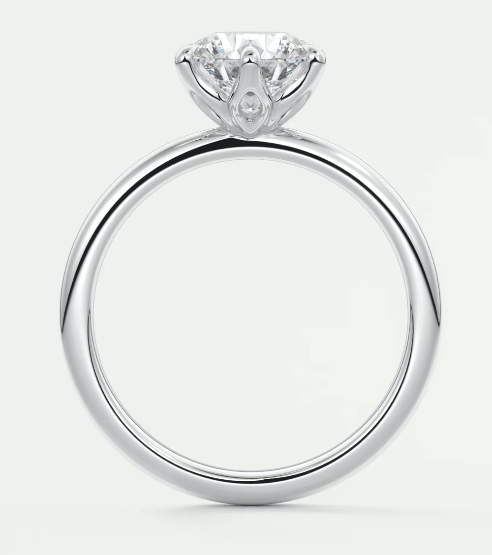 18k white gold solitaire diamond engagement ring with a pear-shaped accent stone.