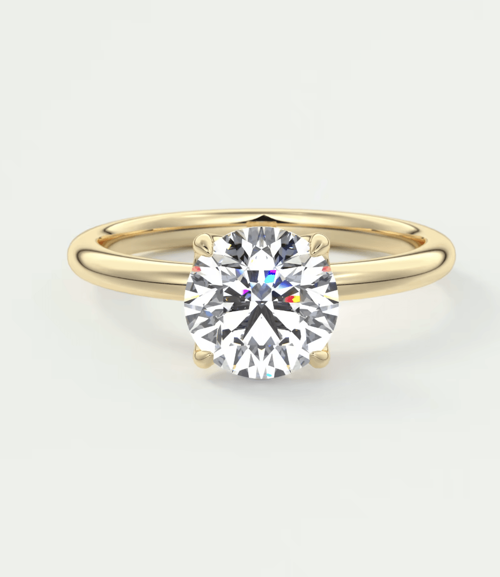 18-karat yellow gold solitaire diamond engagement ring.