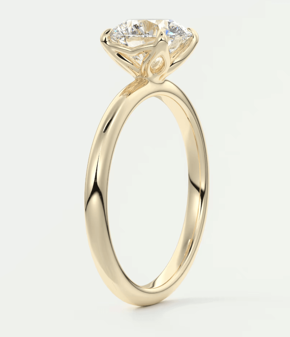 18-karat yellow gold engagement ring with a round diamond.
