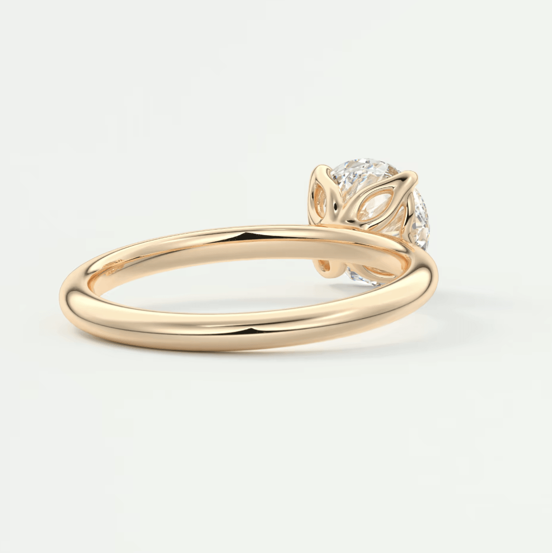 18k gold diamond engagement ring with leaf motif.