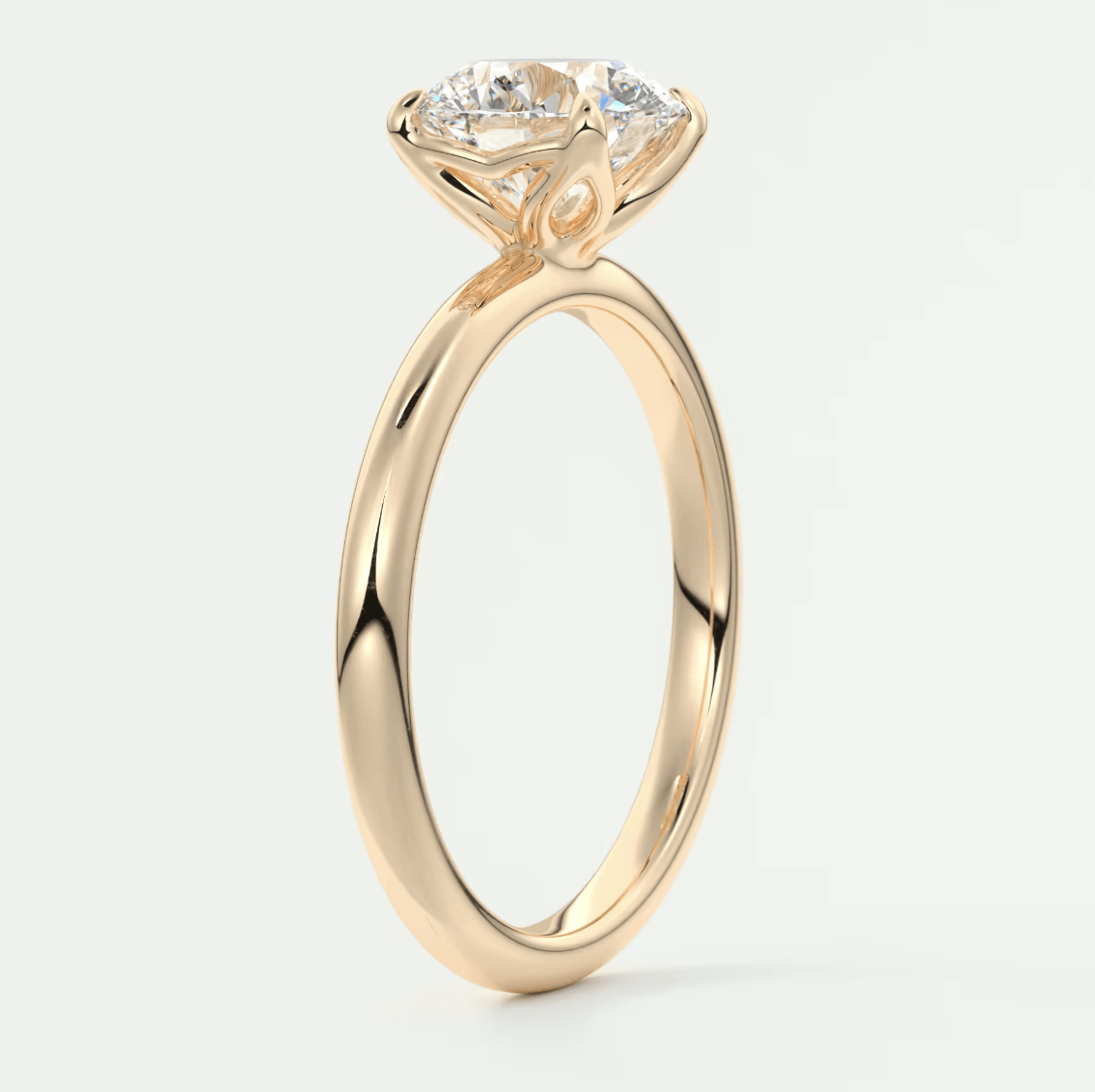 18-karat rose gold engagement ring with a round diamond.