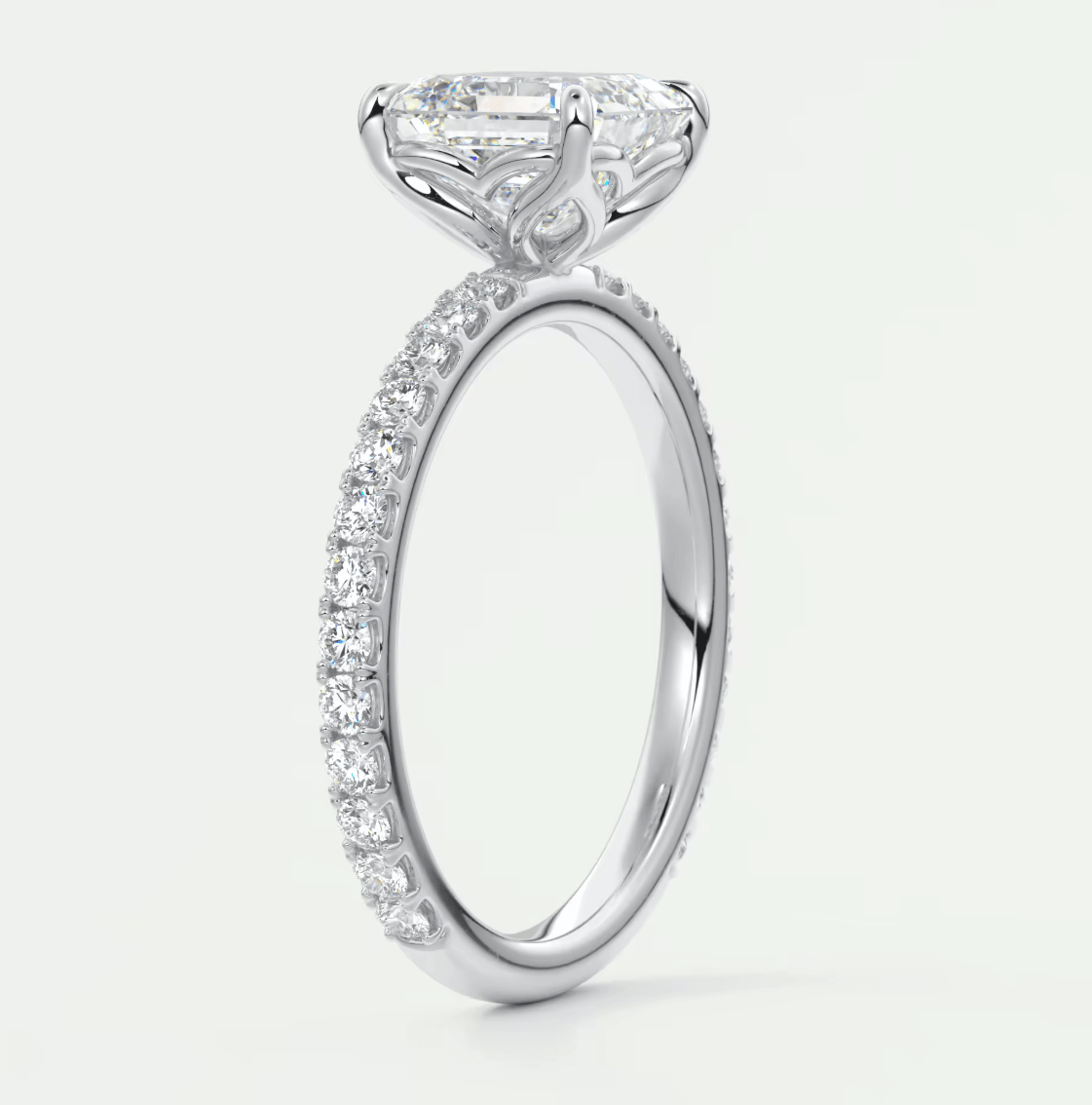 18k white gold engagement ring with a princess cut diamond and pavé set diamonds on the band.