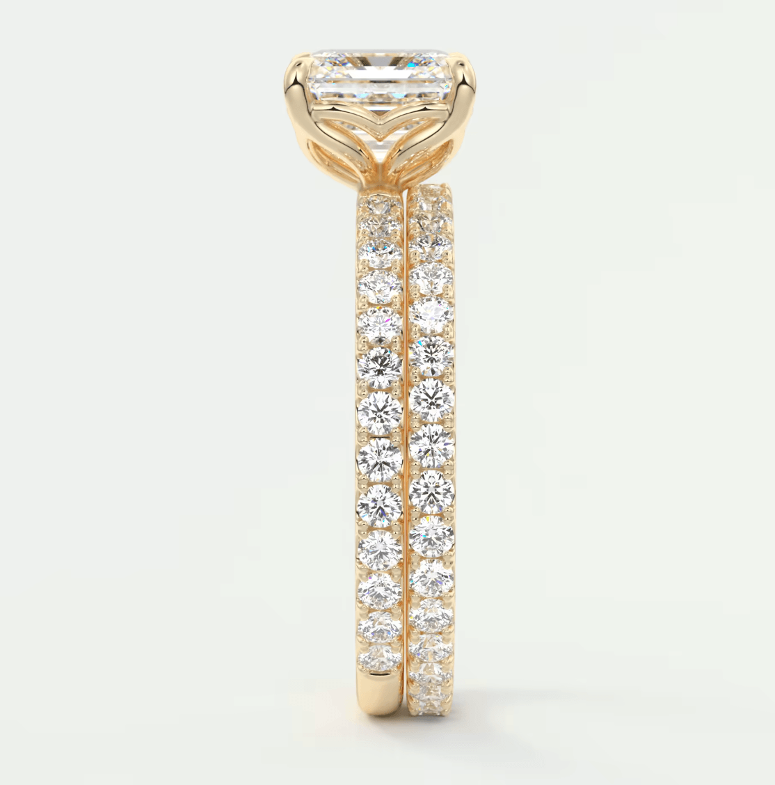 18k yellow gold engagement ring with a princess cut diamond and pavé set diamonds on the band.