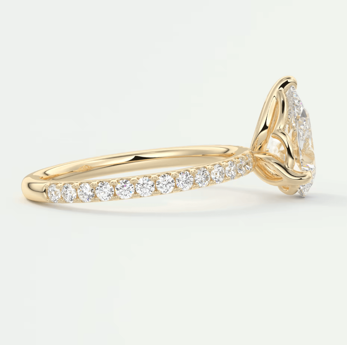 18k yellow gold diamond engagement ring with a round-cut center stone and pave set diamonds on the band.