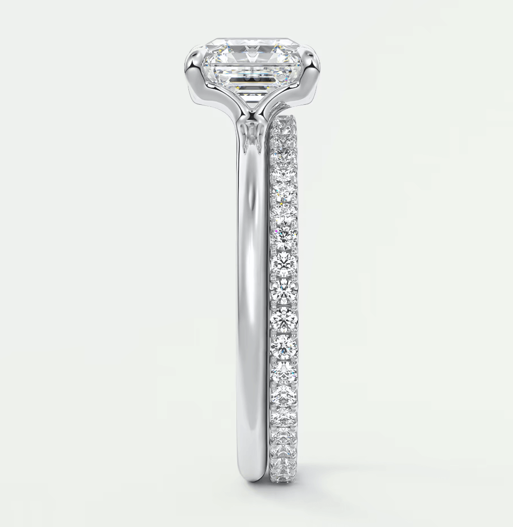 18k white gold engagement ring with a princess cut diamond and pave set diamonds on the band.