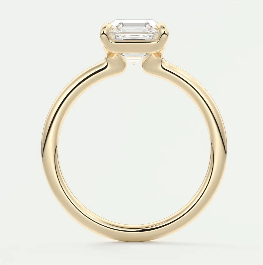 18-karat yellow gold engagement ring with an emerald-cut diamond.