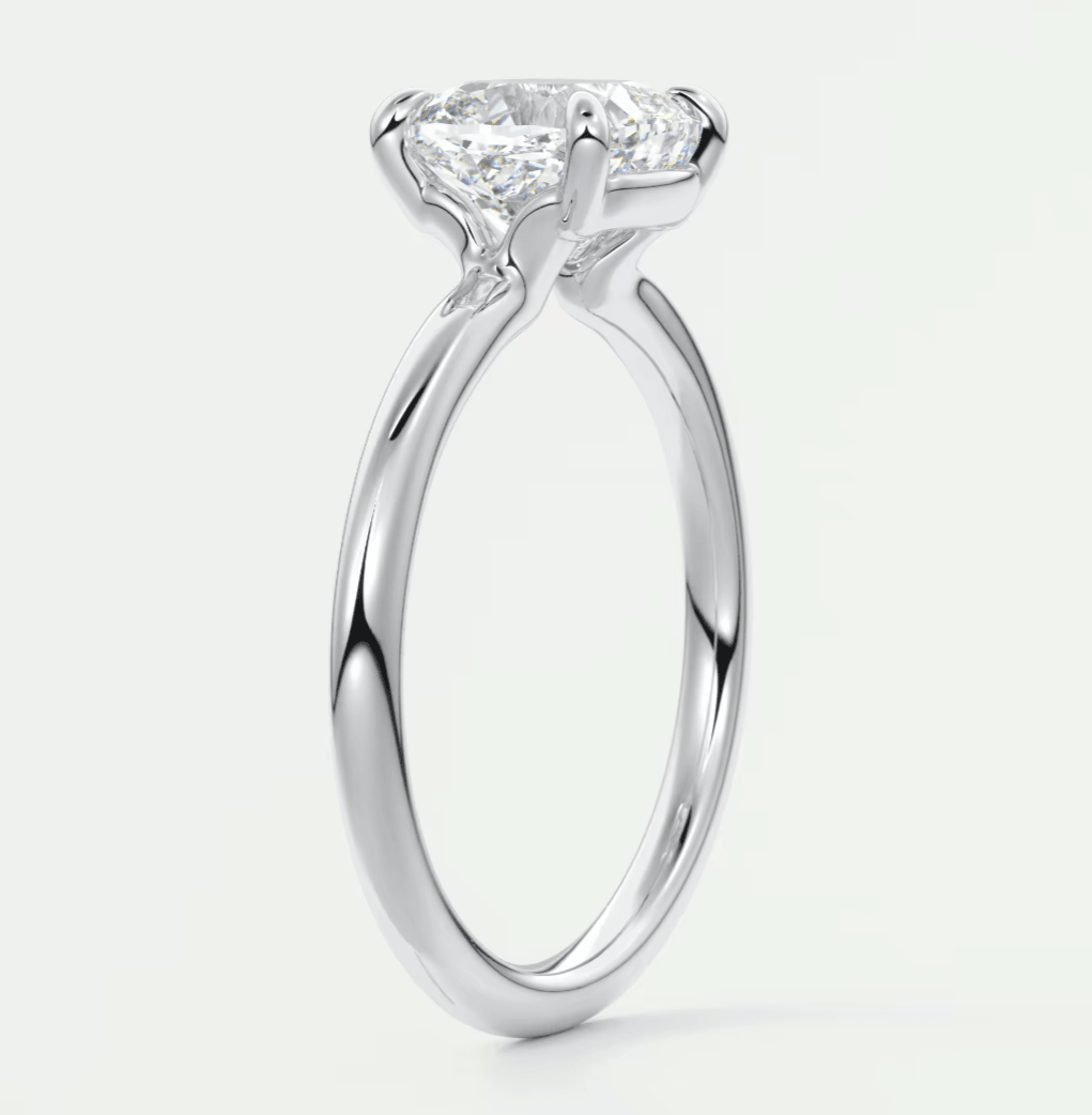 18k white gold solitaire diamond engagement ring with a cushion-cut center stone.