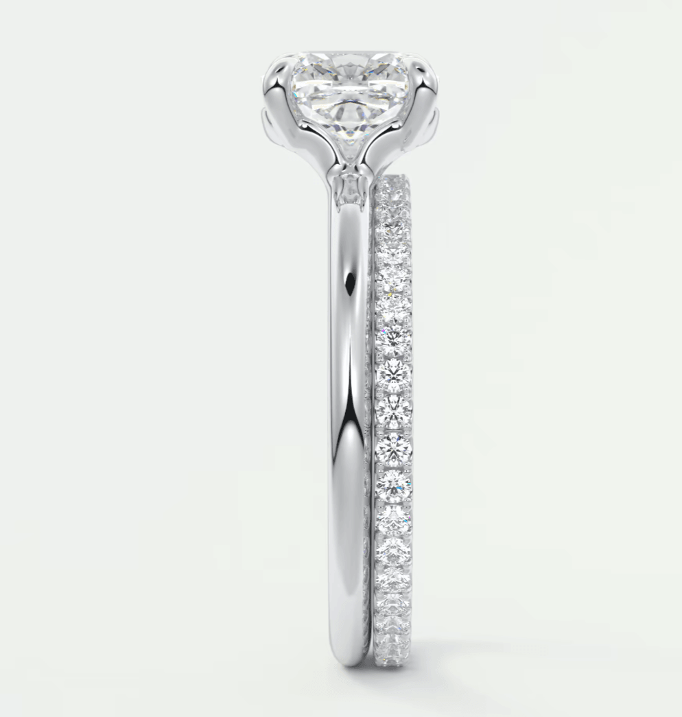 18k white gold diamond engagement ring with a round brilliant cut center stone and pavé set diamonds on the band.