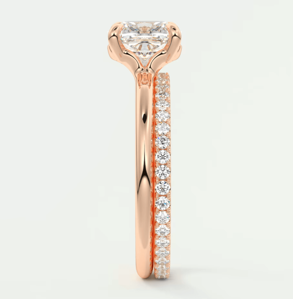 18k rose gold diamond engagement ring with a round brilliant cut center stone and pave set diamonds on the band.