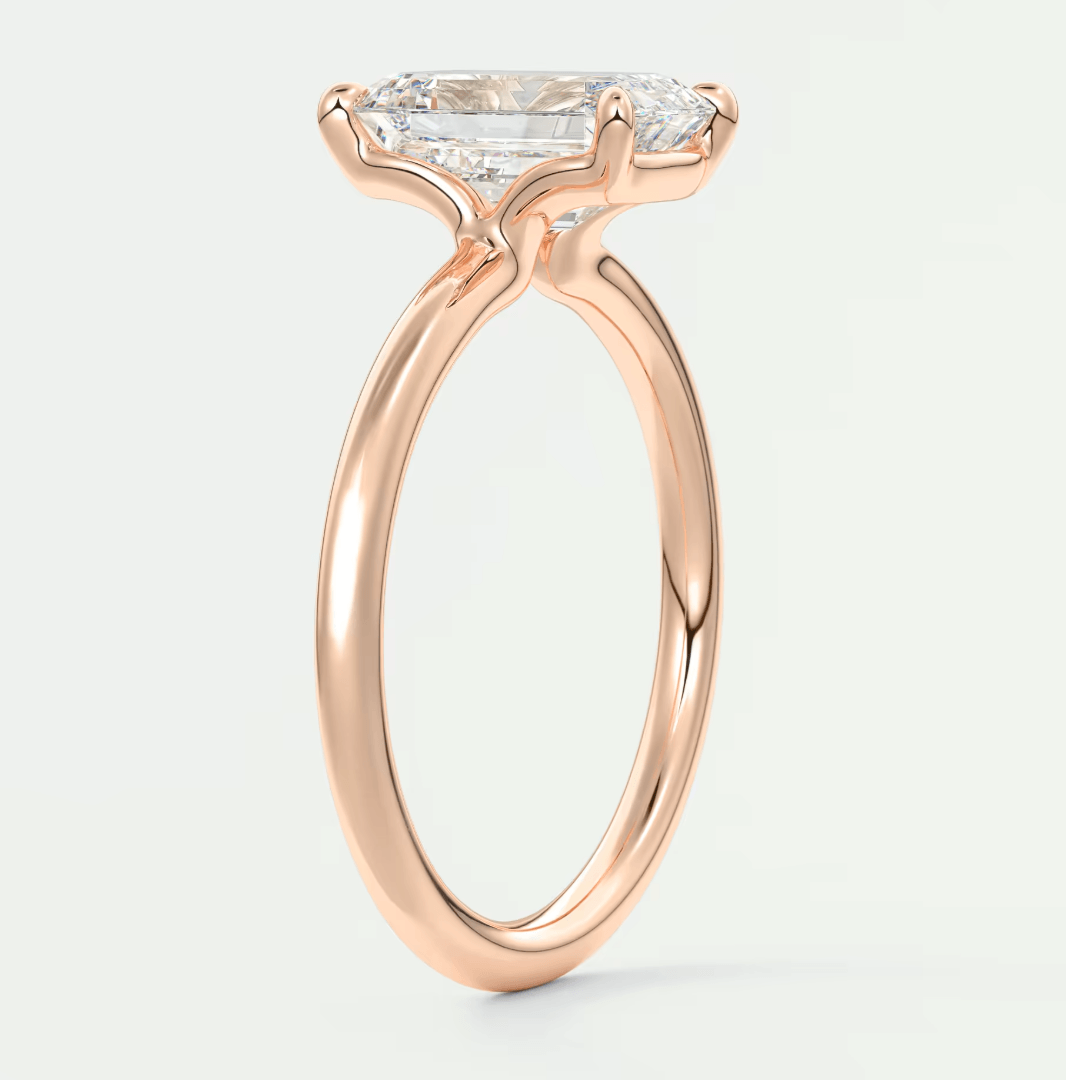 18-karat rose gold engagement ring with a marquise-cut diamond.