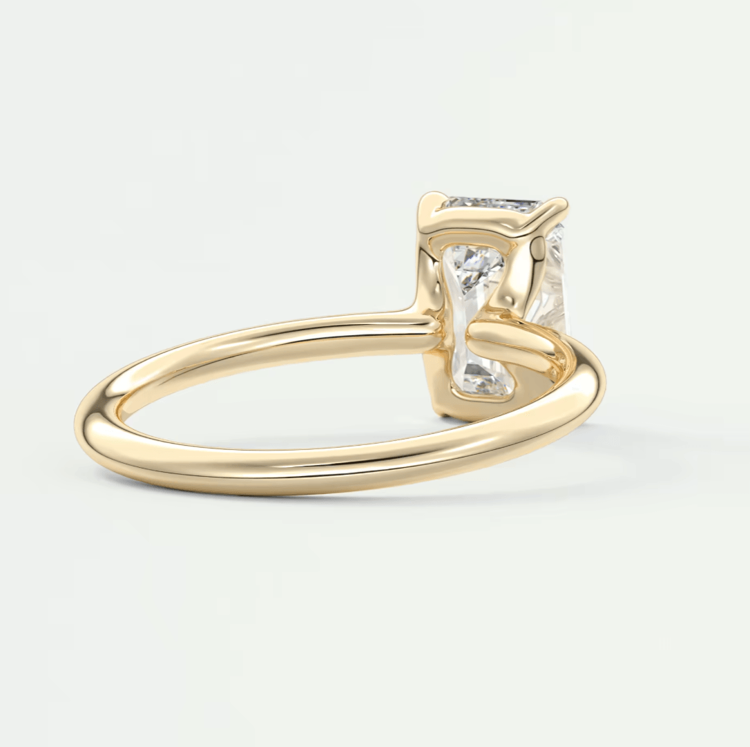 18-karat yellow gold engagement ring with princess-cut diamond.