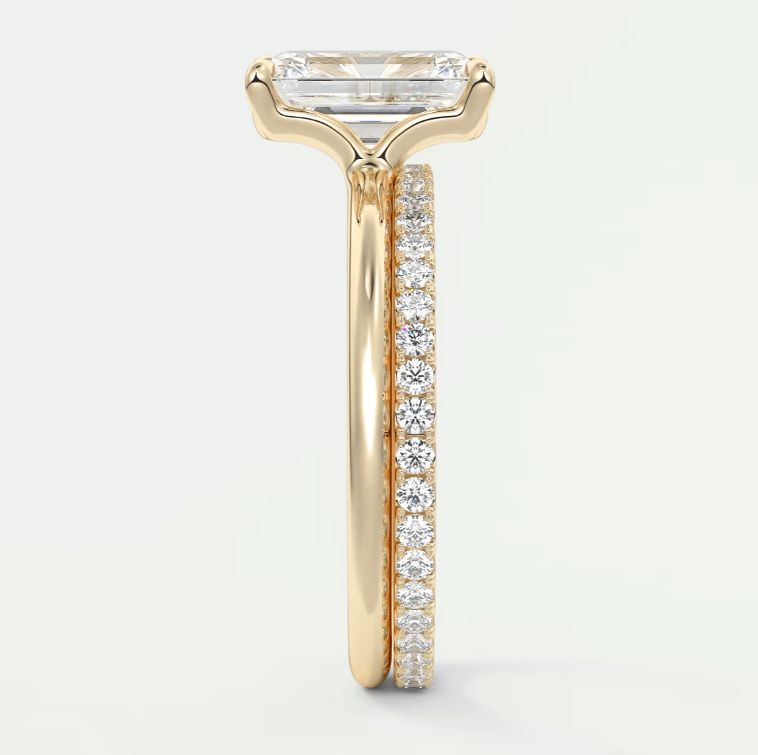 18-karat yellow gold engagement ring with a princess-cut diamond and pavé set diamonds on the band.