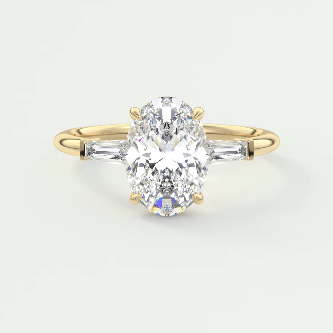 18k yellow gold engagement ring with a pear-shaped diamond and baguette diamonds on the band.