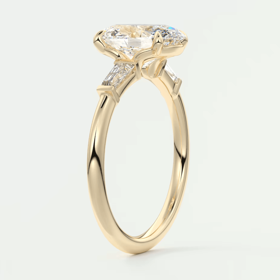 18-karat yellow gold engagement ring with a marquise-cut diamond and two side diamonds, featuring an intricate floral design.