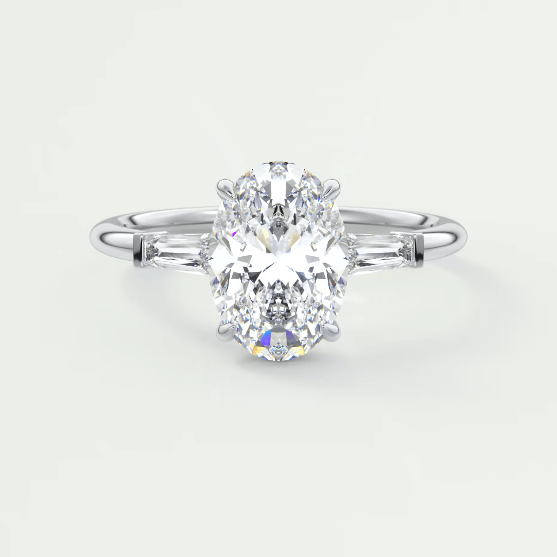 18-karat white gold engagement ring with a marquise-cut diamond and baguette diamonds.