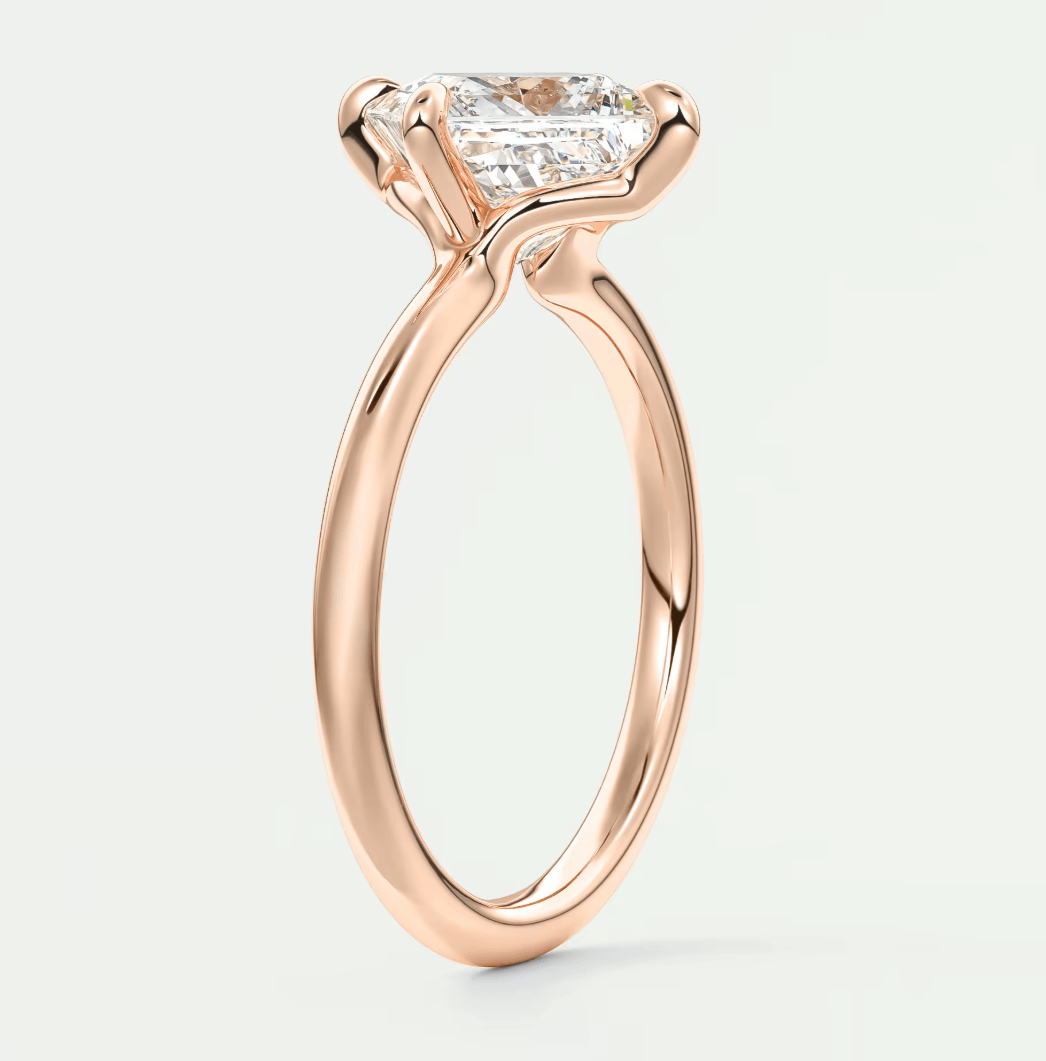Rose gold princess cut diamond engagement ring with a sleek, modern design.