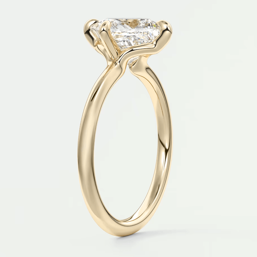 18-karat yellow gold engagement ring with a princess-cut diamond.