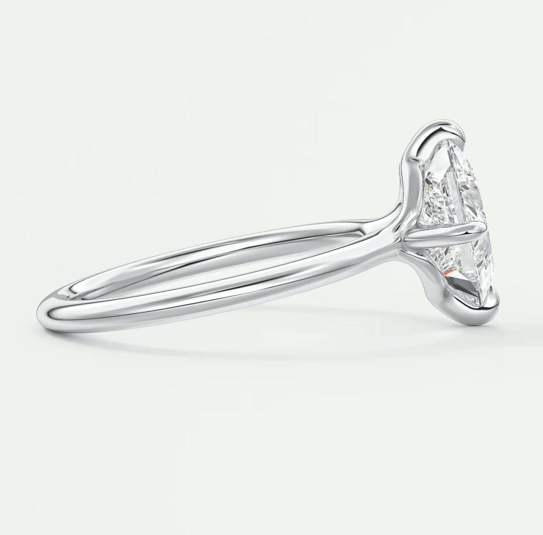18k white gold solitaire diamond engagement ring with a marquise-cut stone.