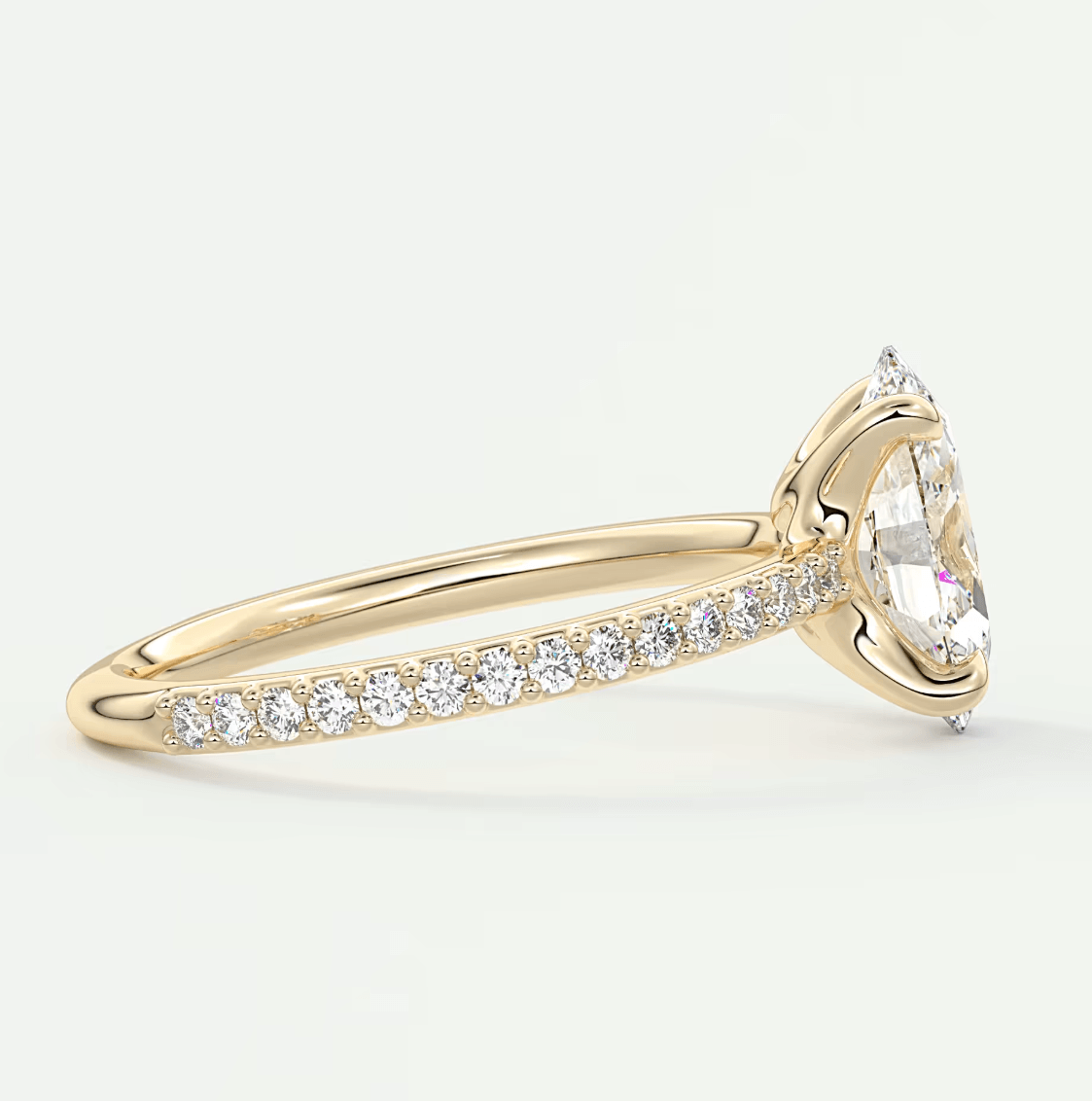 18k yellow gold diamond engagement ring with a marquise-cut center stone and pave-set diamonds on the band.