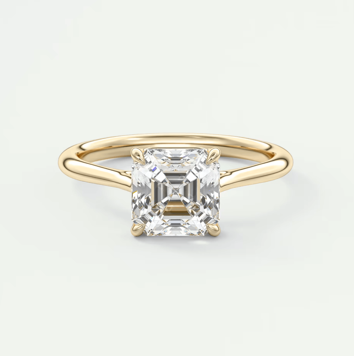 18-karat yellow gold engagement ring with a princess-cut diamond.