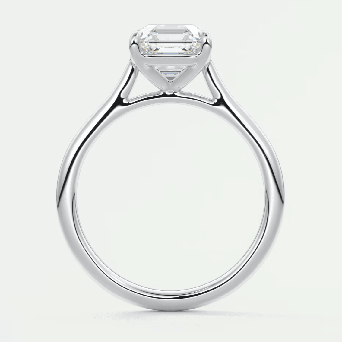 18k white gold engagement ring with an emerald-cut diamond.