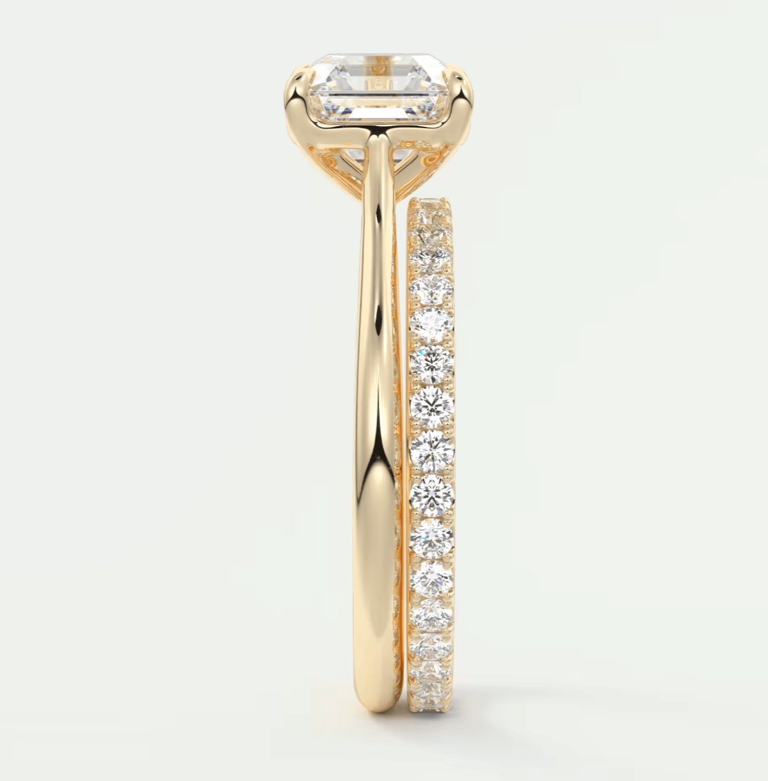 18k yellow gold engagement ring with emerald-cut diamond and channel-set diamonds, featuring a sleek modern design.