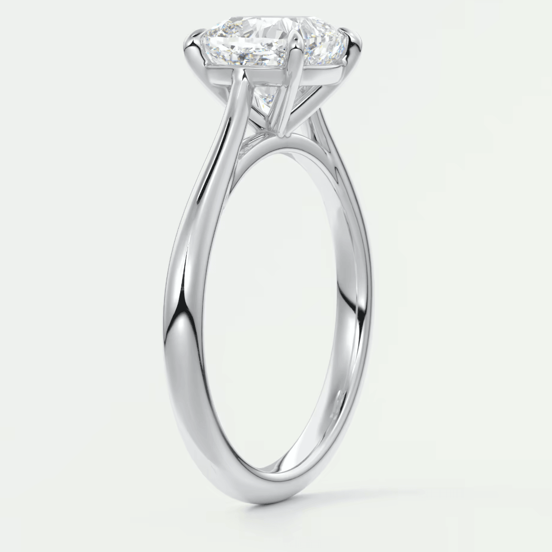 18-karat white gold solitaire engagement ring with a cushion-cut diamond.