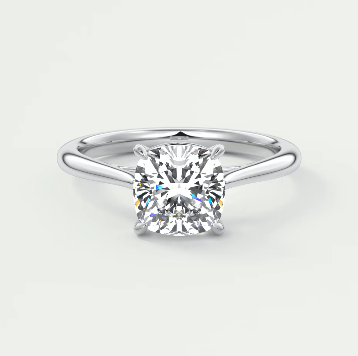 Cushion-cut diamond engagement ring with a white gold band.