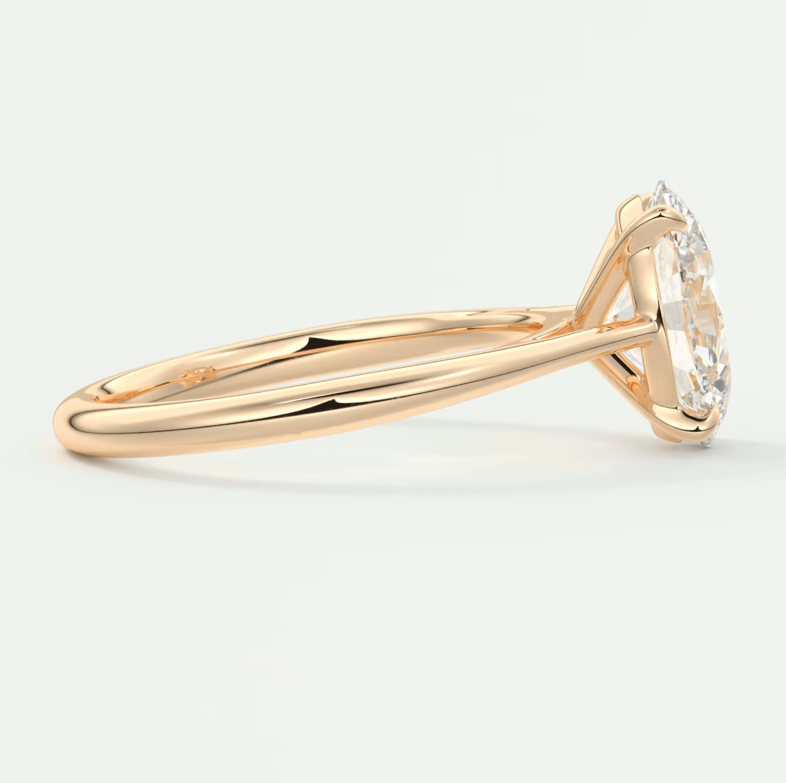 18k yellow gold diamond engagement ring with a marquise-cut center stone and four prongs.