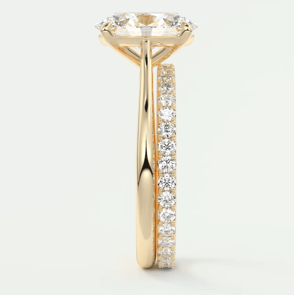 18-karat yellow gold engagement ring with a cushion-cut diamond center stone and pavé set diamonds on the band.