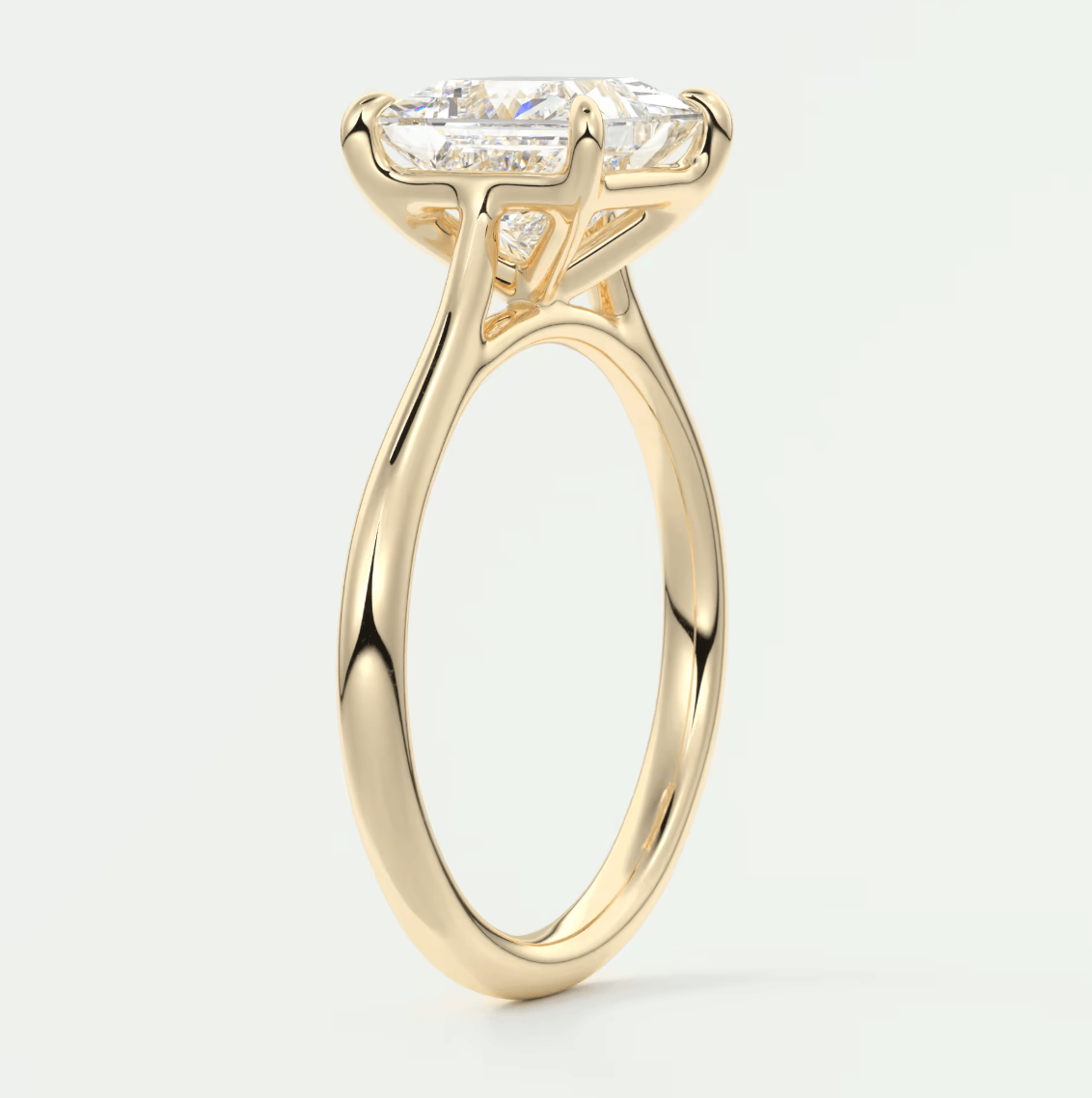 18-karat yellow gold engagement ring with a princess-cut diamond.