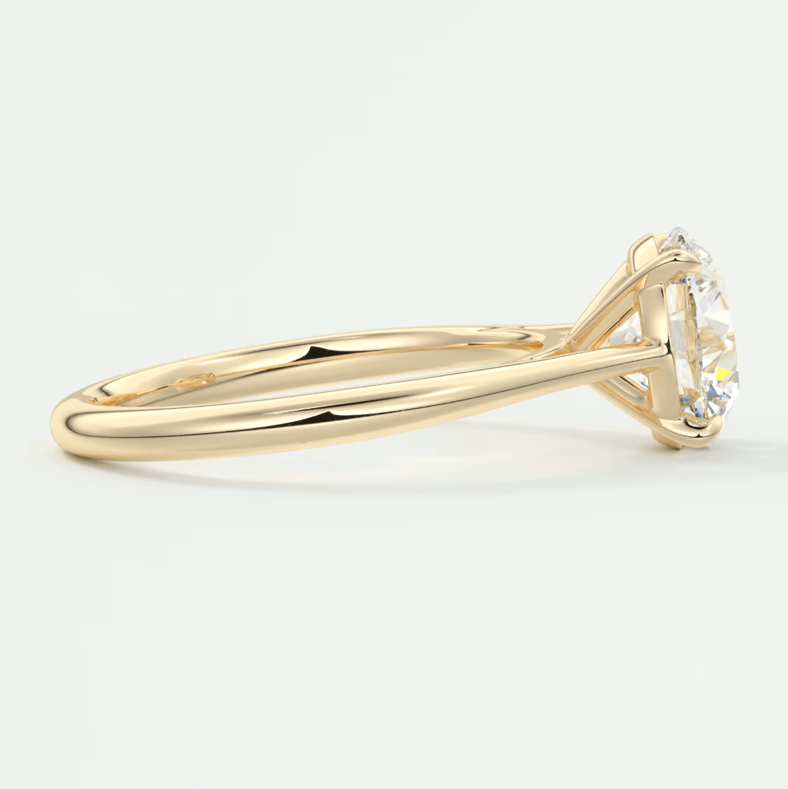 18-karat yellow gold solitaire engagement ring with a round diamond.