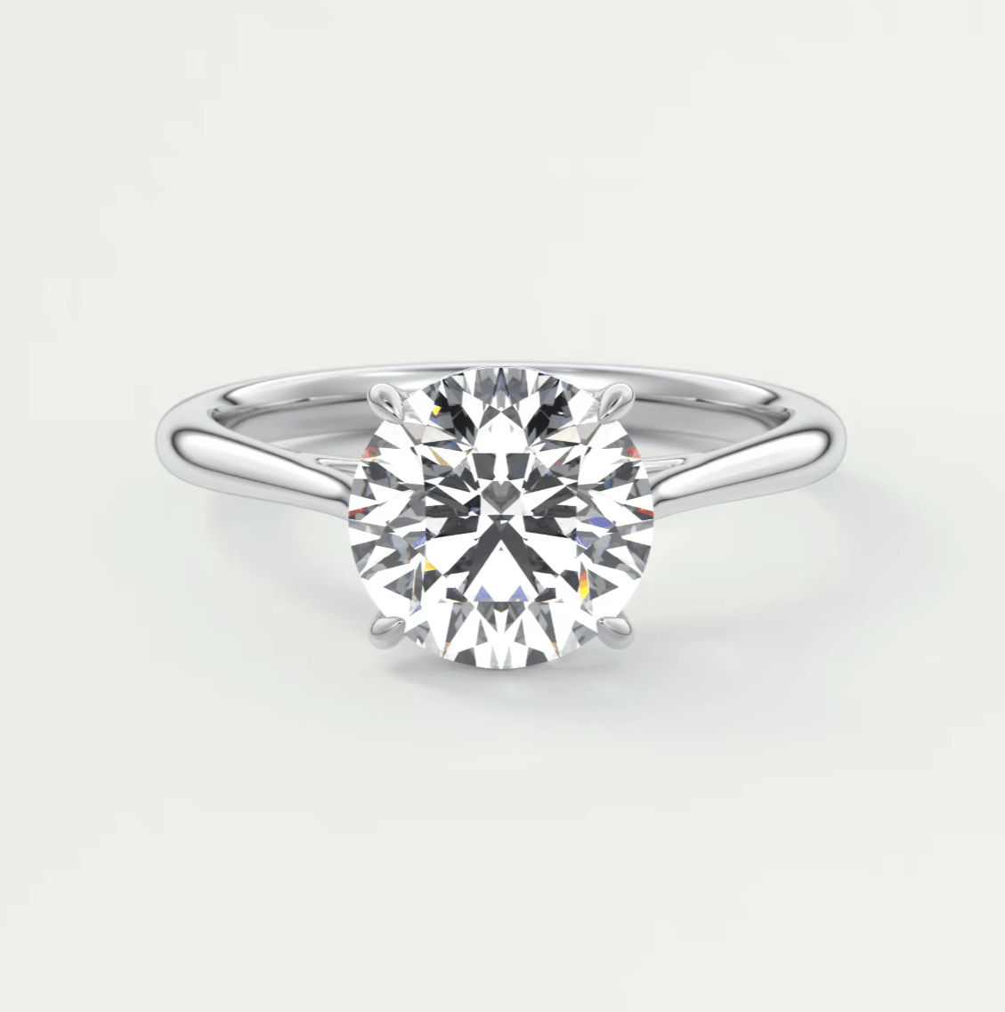 18-karat white gold solitaire diamond engagement ring.