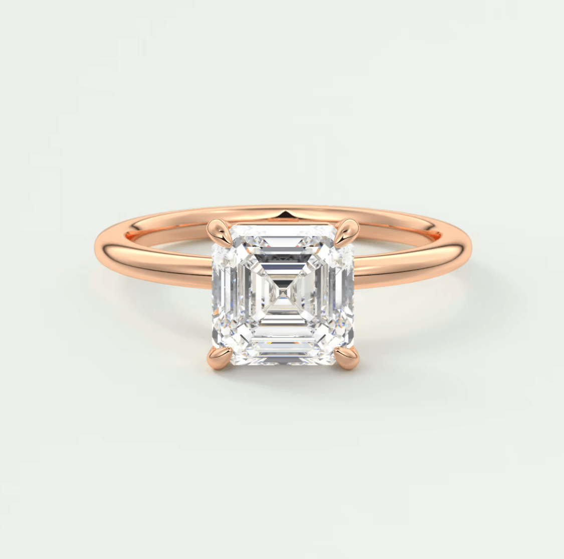 18-karat rose gold engagement ring with a square-cut diamond.