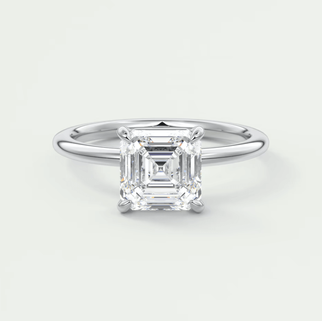Asscher cut diamond engagement ring with white gold band.