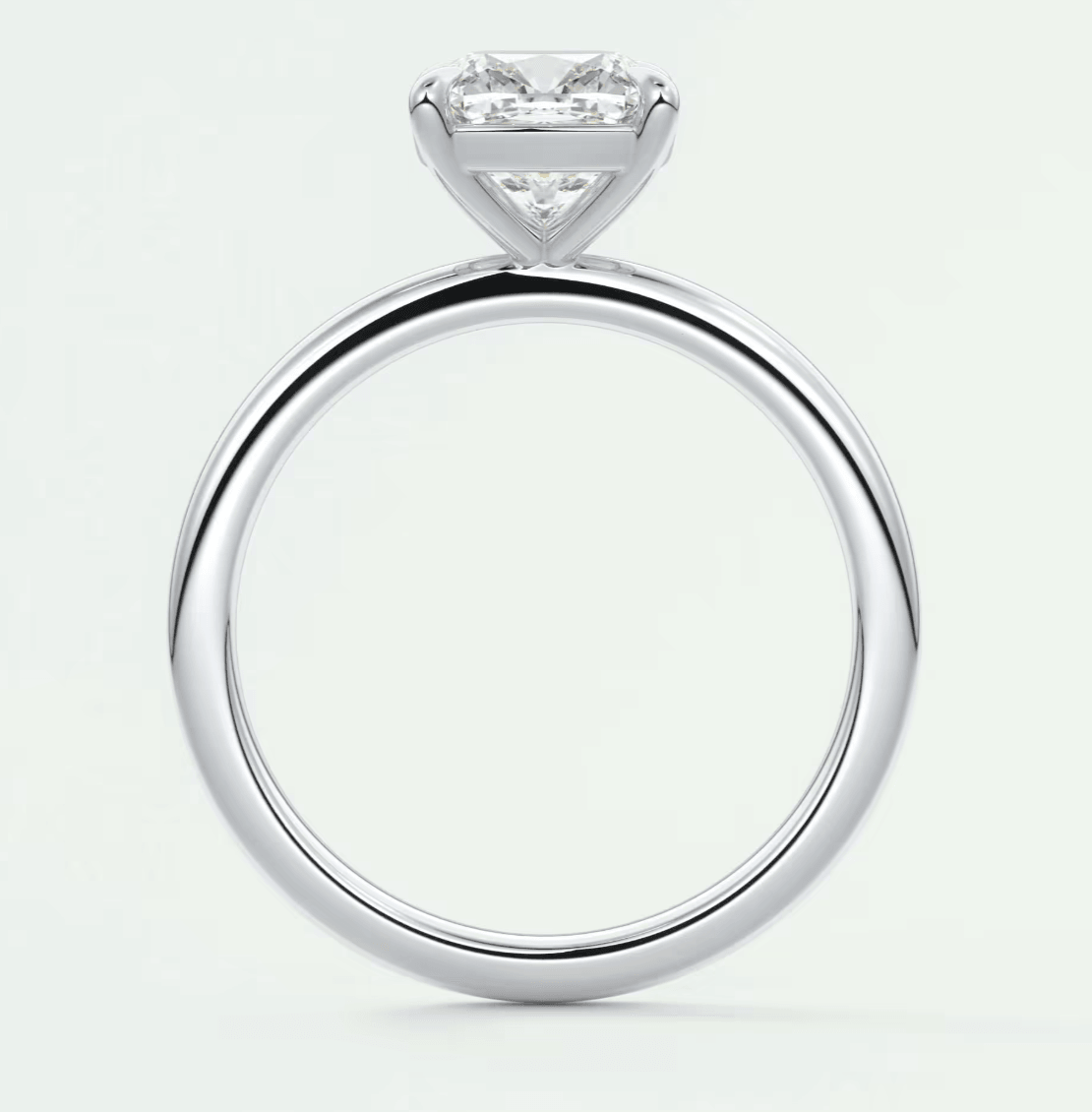 18k white gold solitaire engagement ring with a princess cut diamond.