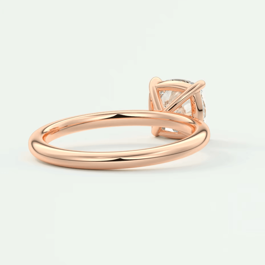 Rose gold diamond engagement ring with a princess cut gemstone and delicate band design.