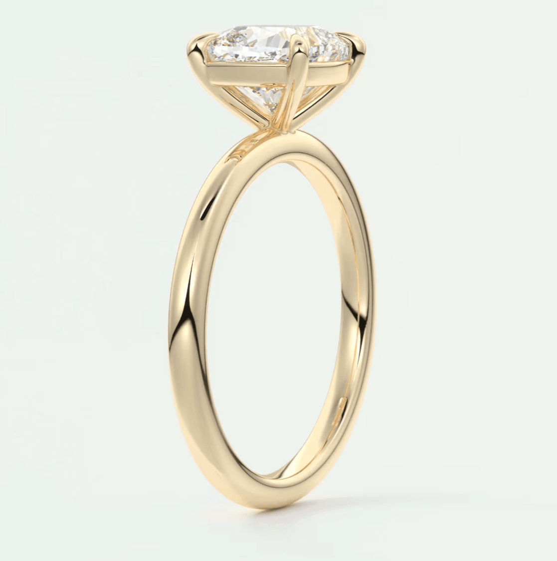 18k yellow gold engagement ring with princess cut diamond and small diamonds on band.