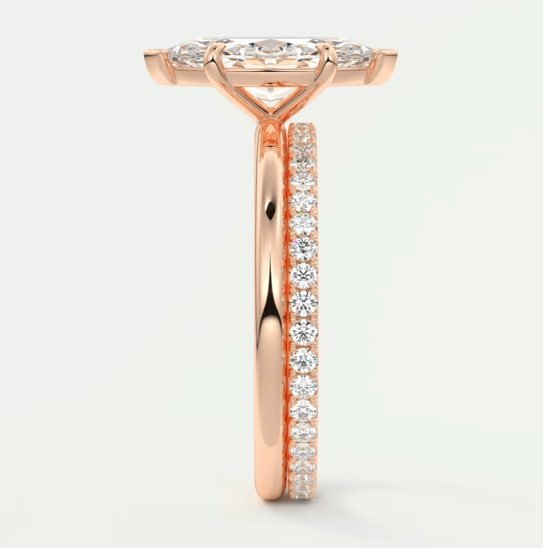 18k rose gold diamond engagement ring with a halo design and side stones.