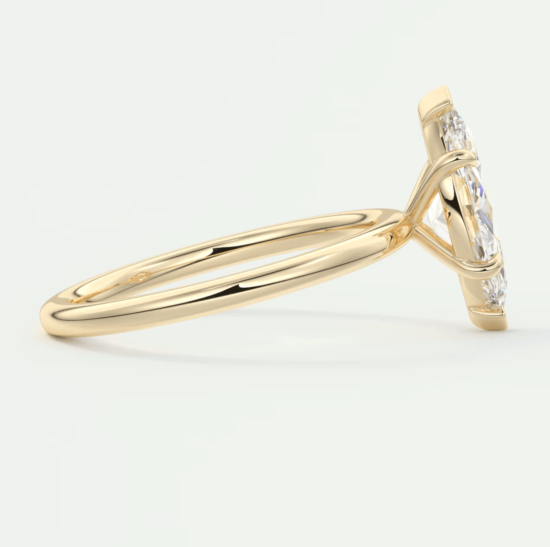 18k yellow gold engagement ring with marquise-cut diamond and smaller diamonds on the band.