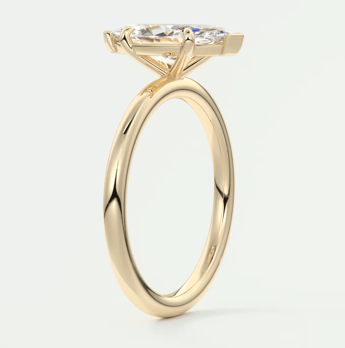 18k yellow gold engagement ring with a marquise-cut diamond.
