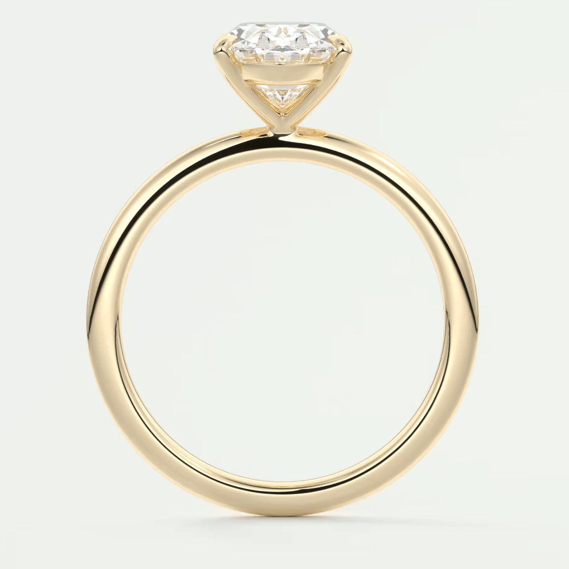 18k yellow gold solitaire diamond engagement ring with a cushion-cut center stone.
