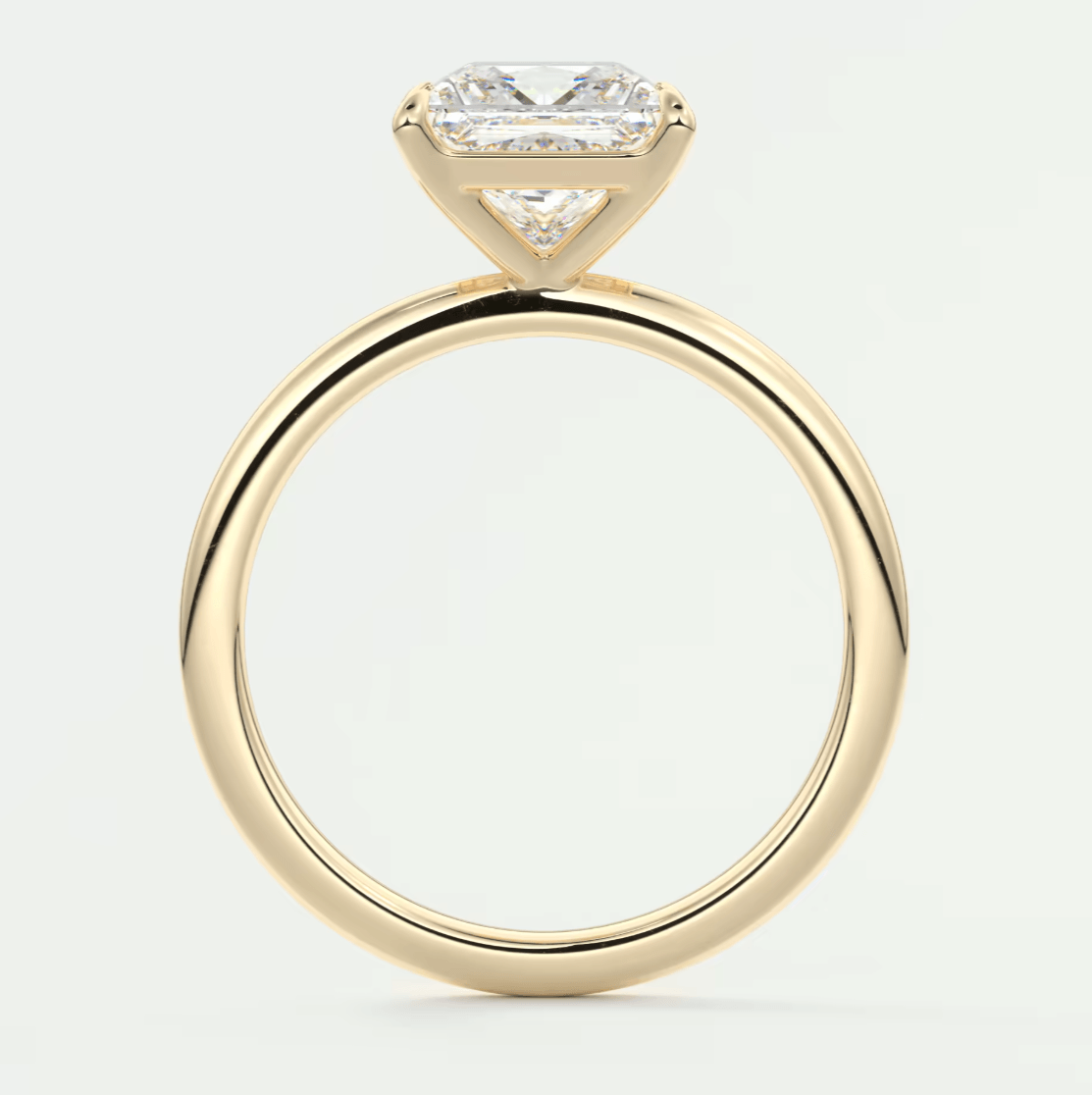 18-karat yellow gold engagement ring with an emerald-cut diamond.
