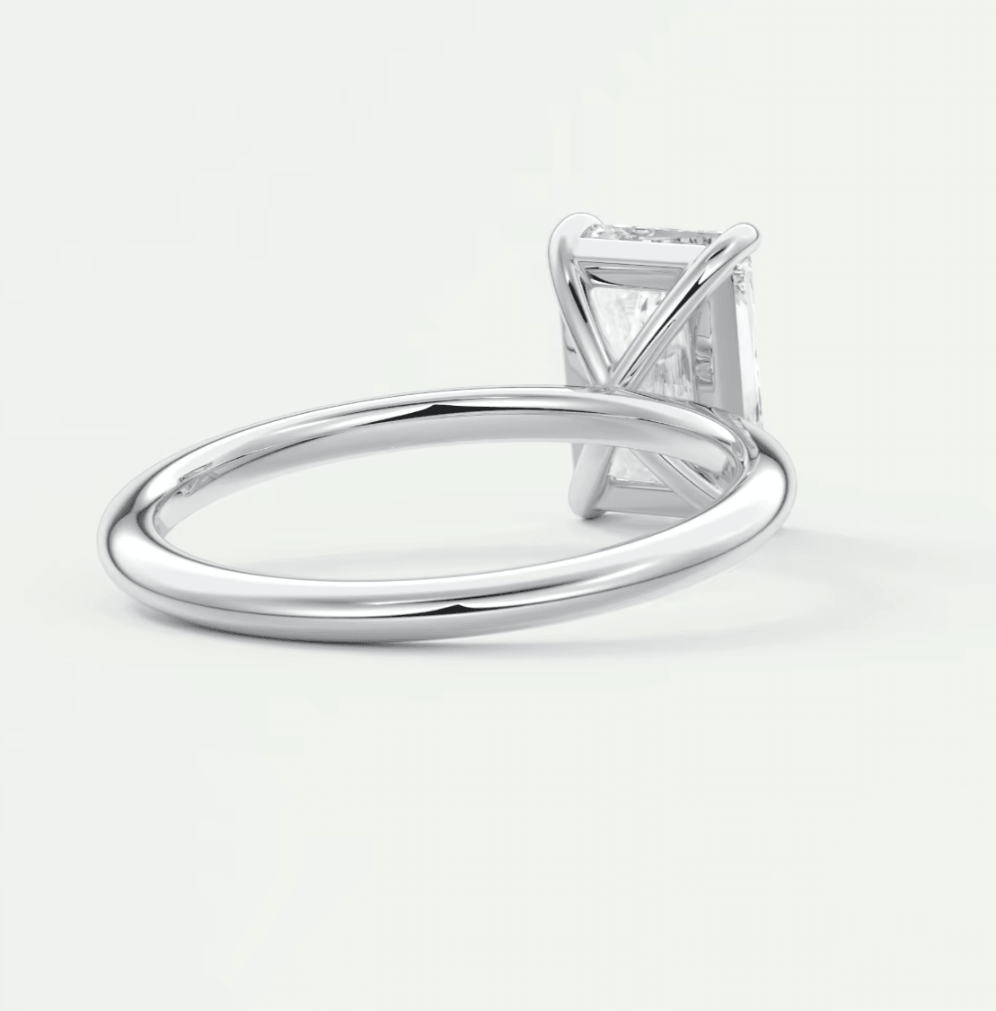 18-karat white gold solitaire engagement ring with a princess-cut diamond.