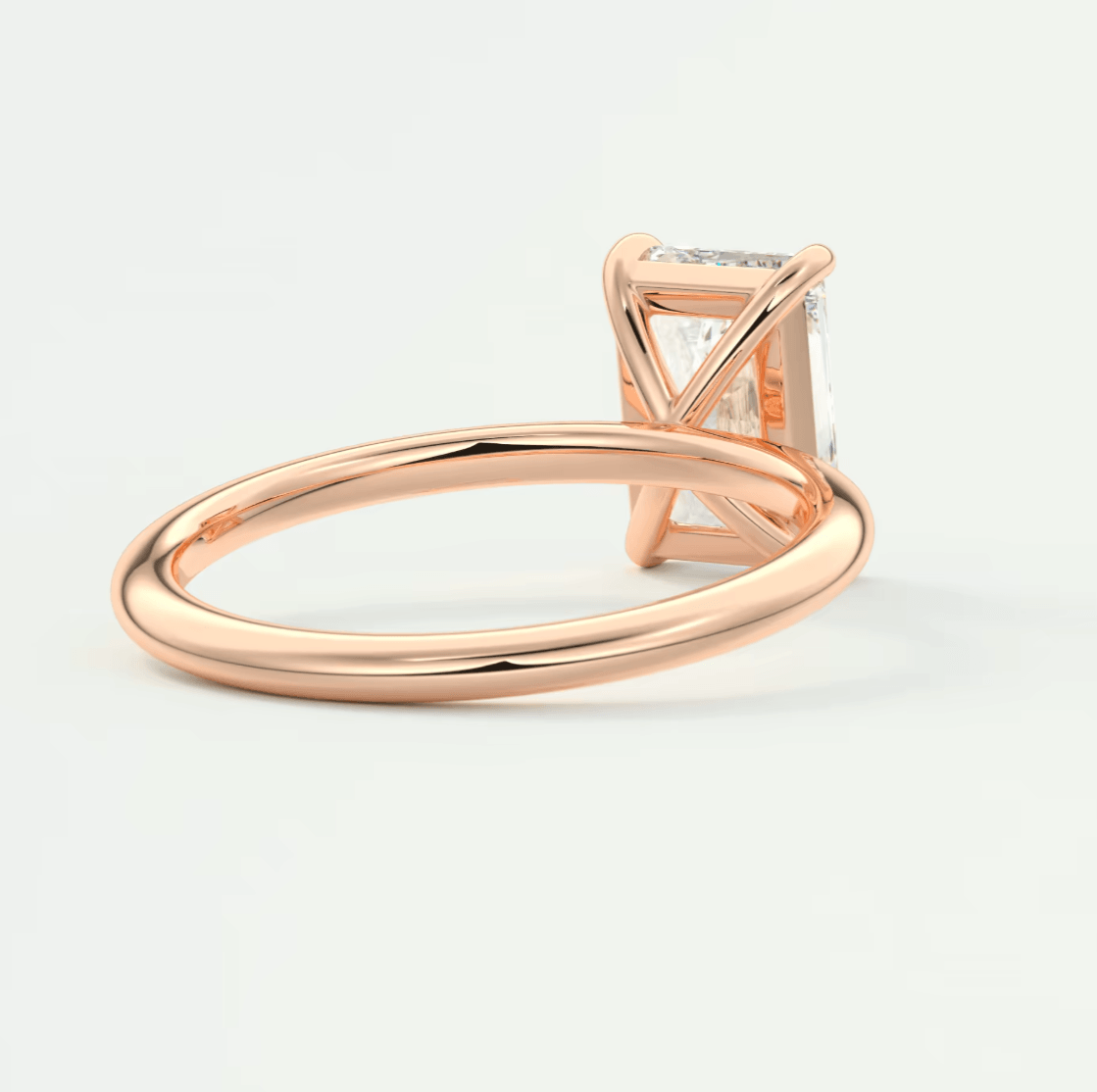 18-karat rose gold engagement ring with a princess-cut diamond.