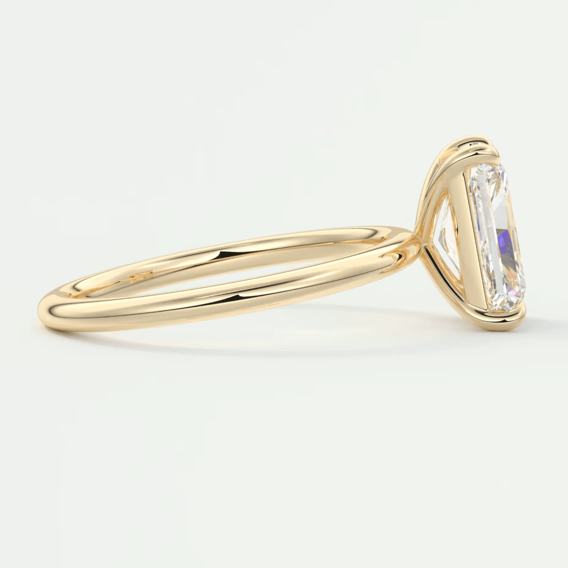 18k yellow gold emerald-cut diamond engagement ring.