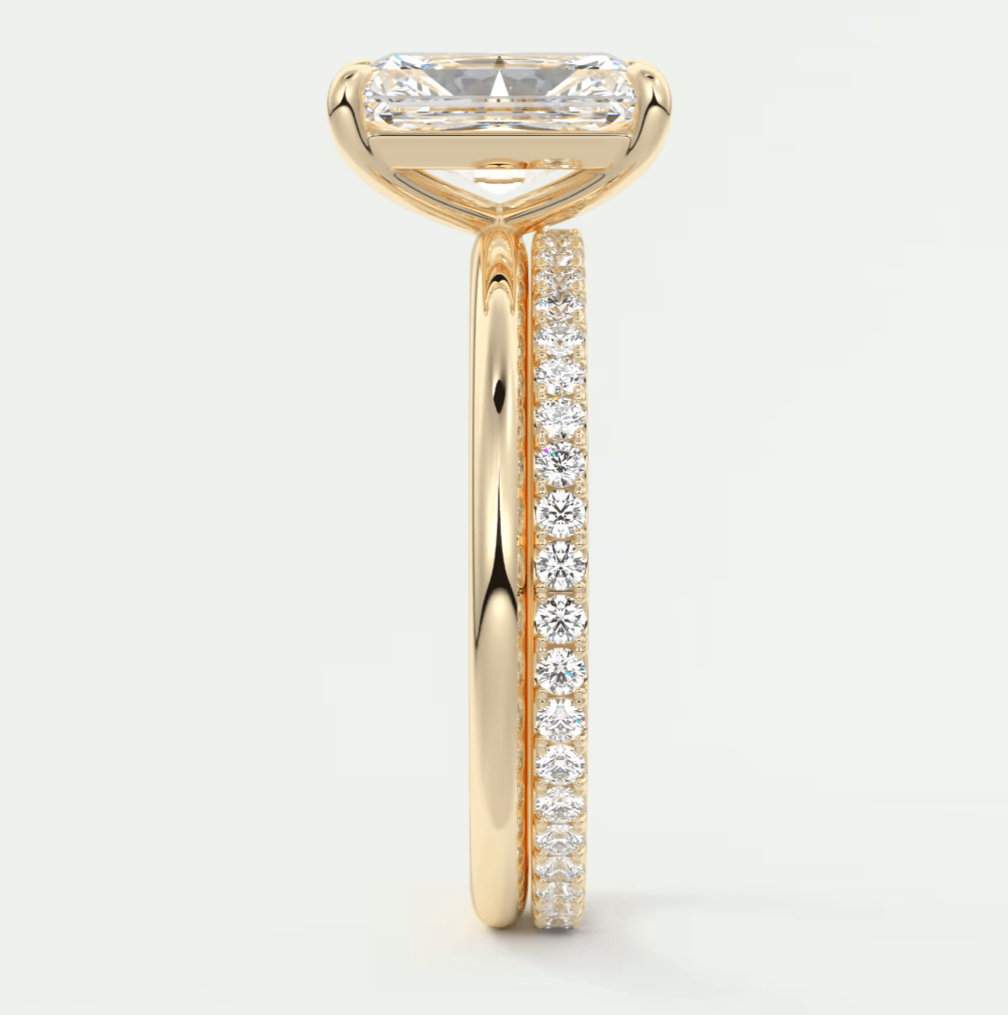 18k yellow gold engagement ring with a princess cut diamond and pavé side stones.